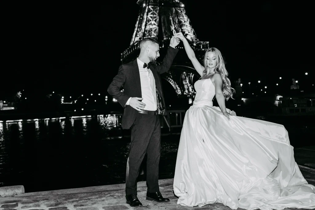 Brautpaar lacht gemeinsam vor dem Eiffelturm während Hochzeitsfotos in Paris.